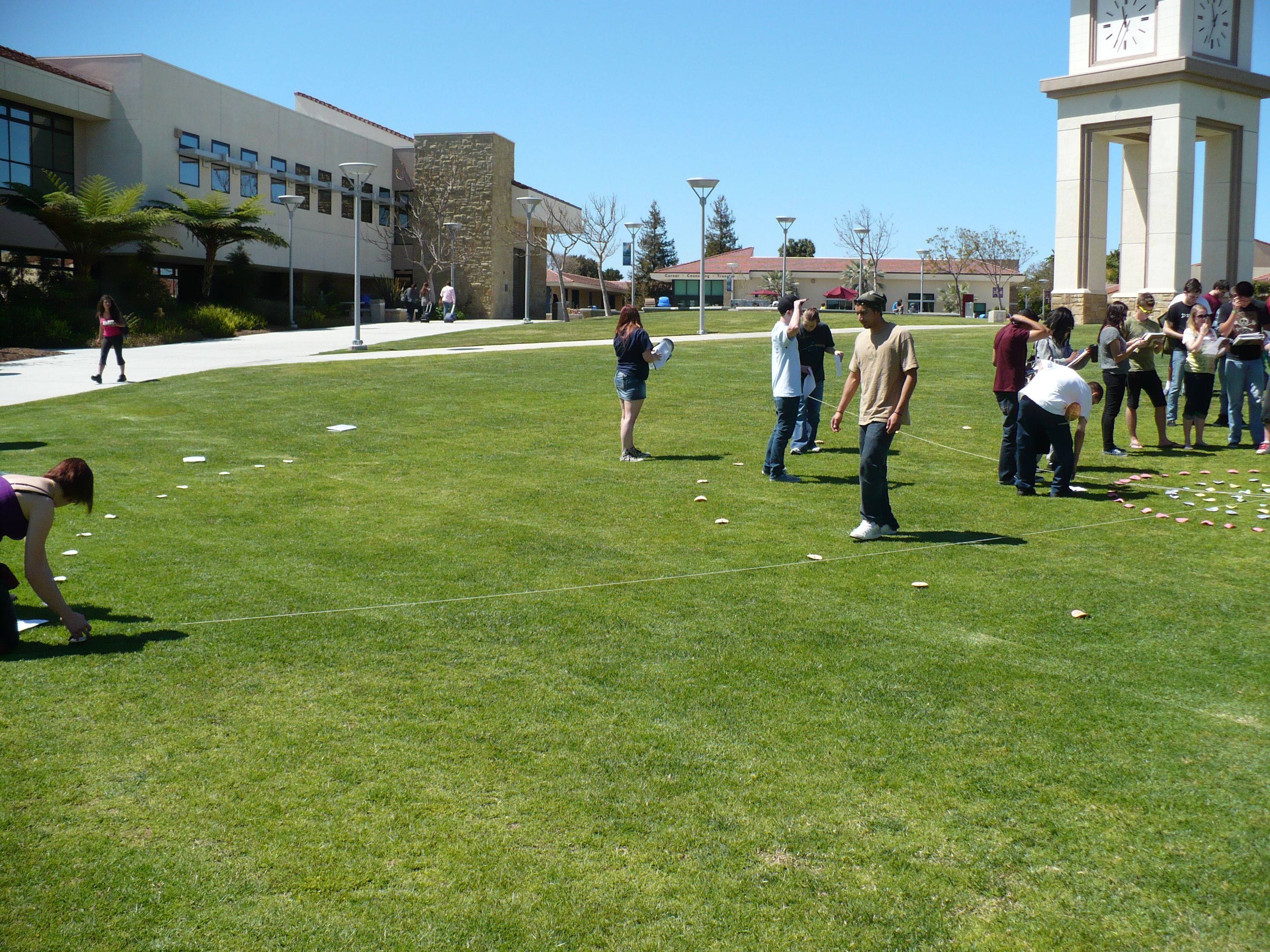 students assembling human orrery outside on lawn